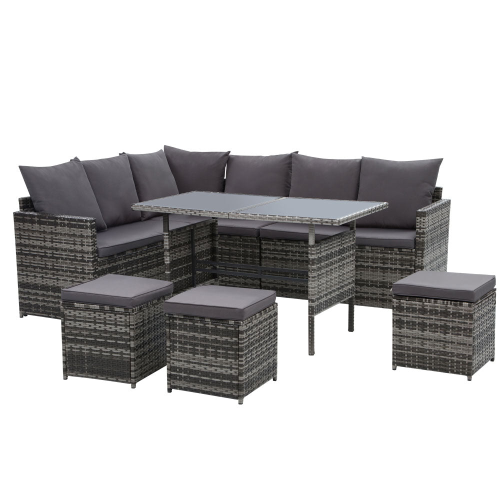 Outdoor wicker sectional sofa set with dark gray cushions, corner table, and ottoman stools