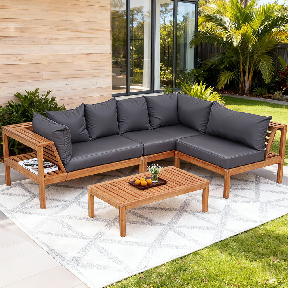 Outdoor corner sofa set with dark gray cushions and light wood frame; includes side table