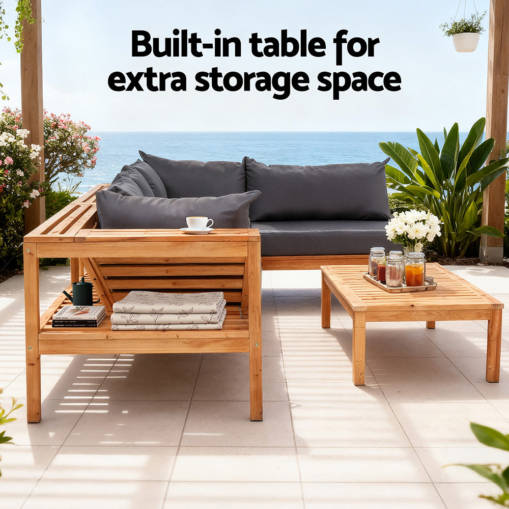 Outdoor sofa with dark gray cushions, light wood frame, and built-in shelf/side table