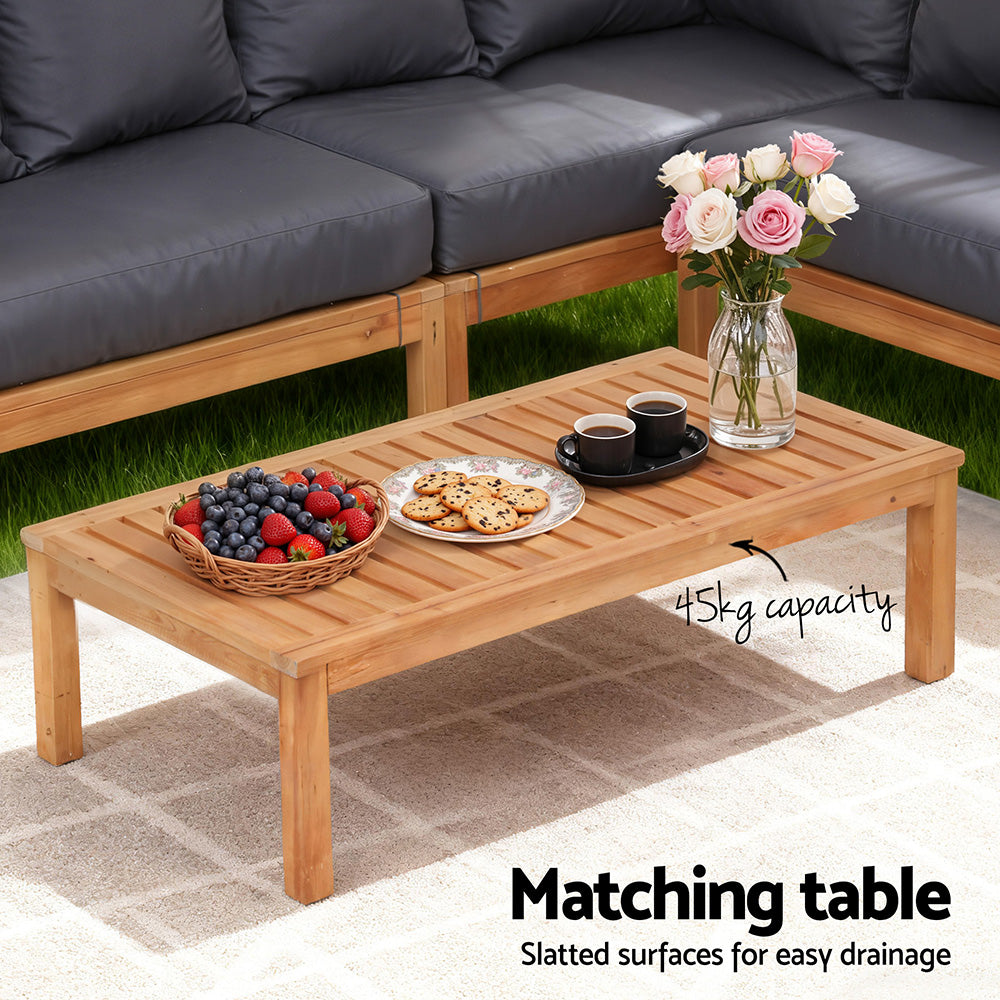 Wood coffee table with slatted top, suited for use with dark gray outdoor sofa