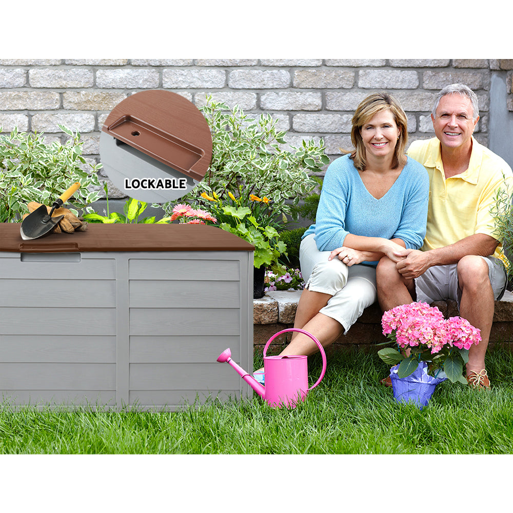 Lockable outdoor storage box with brown lid and grey panels, outdoors on grass
