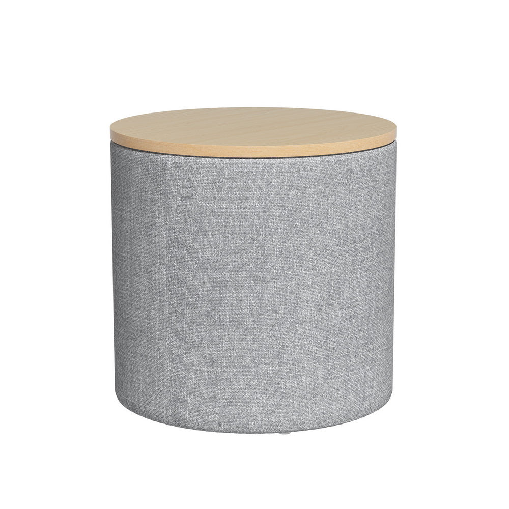 Grey round linen storage ottoman with a light wood-tone top and upholstered sides.