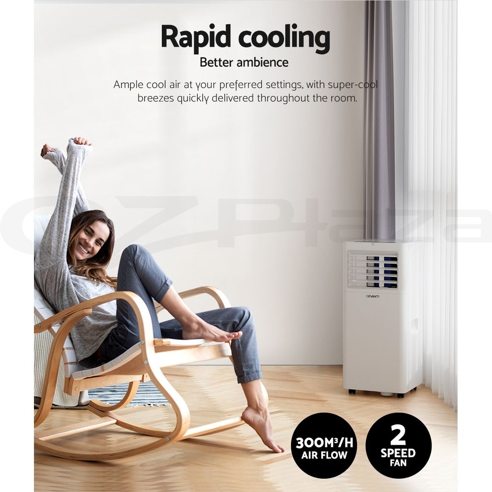 Portable air conditioner next to a curtain, with front vent grille