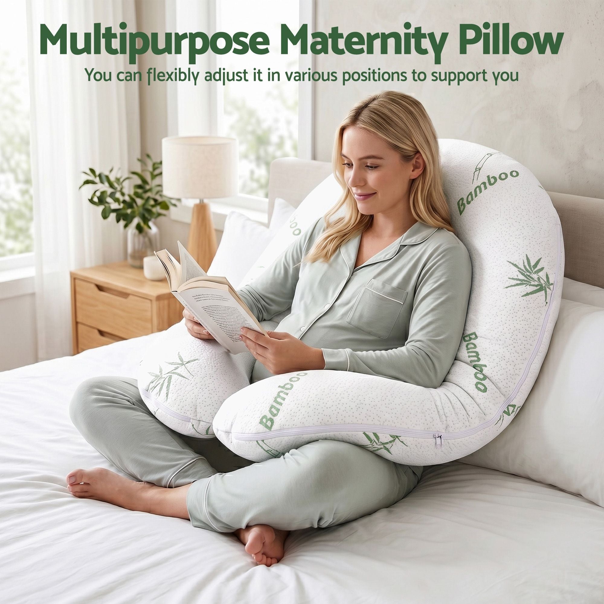C-shaped maternity body pillow with white bamboo-fiber cover, used while reading
