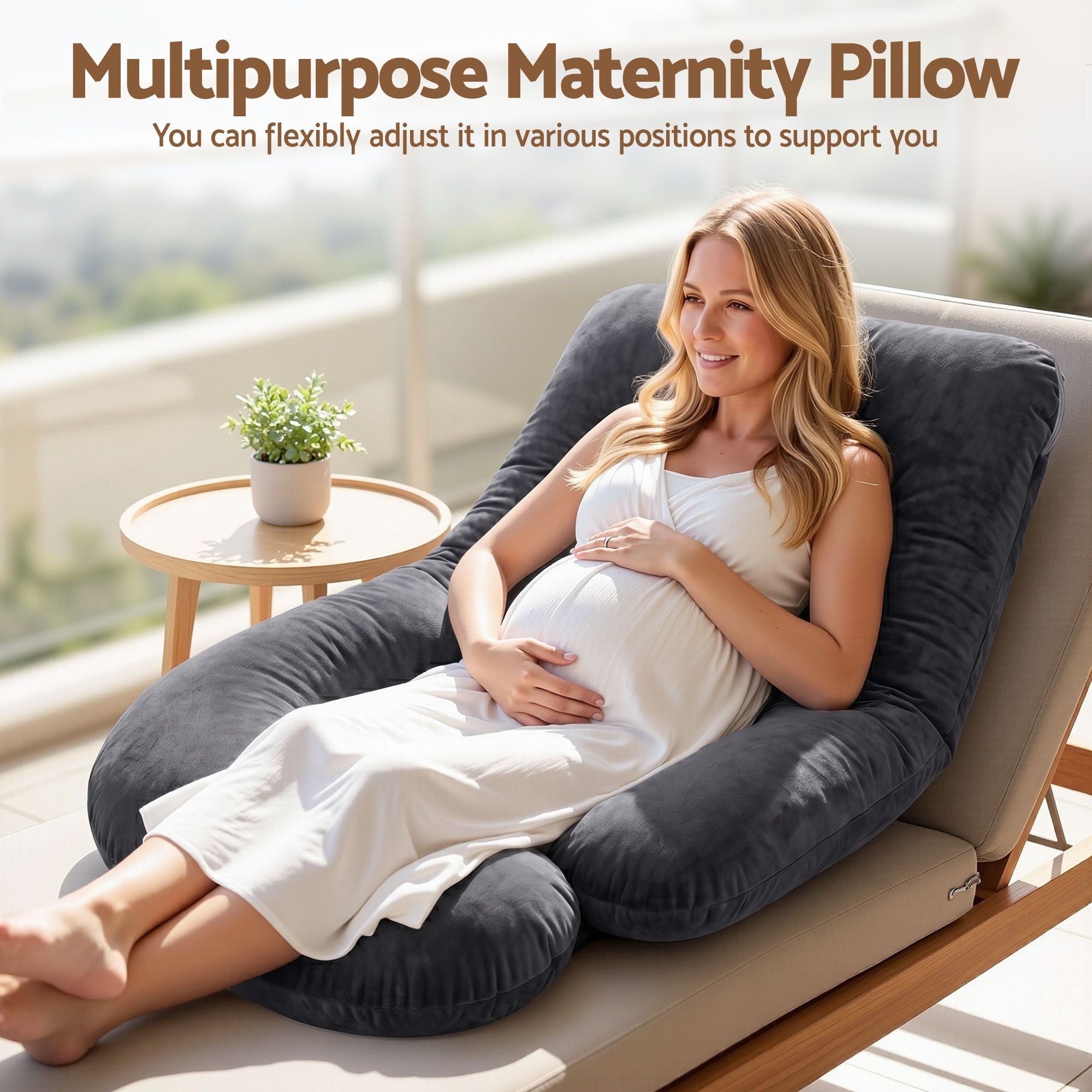 Dark grey G-shaped pregnancy body pillow supporting back and belly on a bed