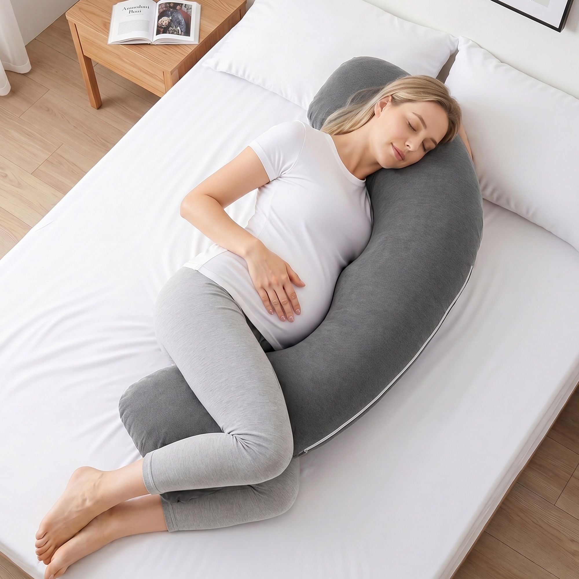 Grey L-shaped pregnancy pillow with curved support for head, neck, and belly.