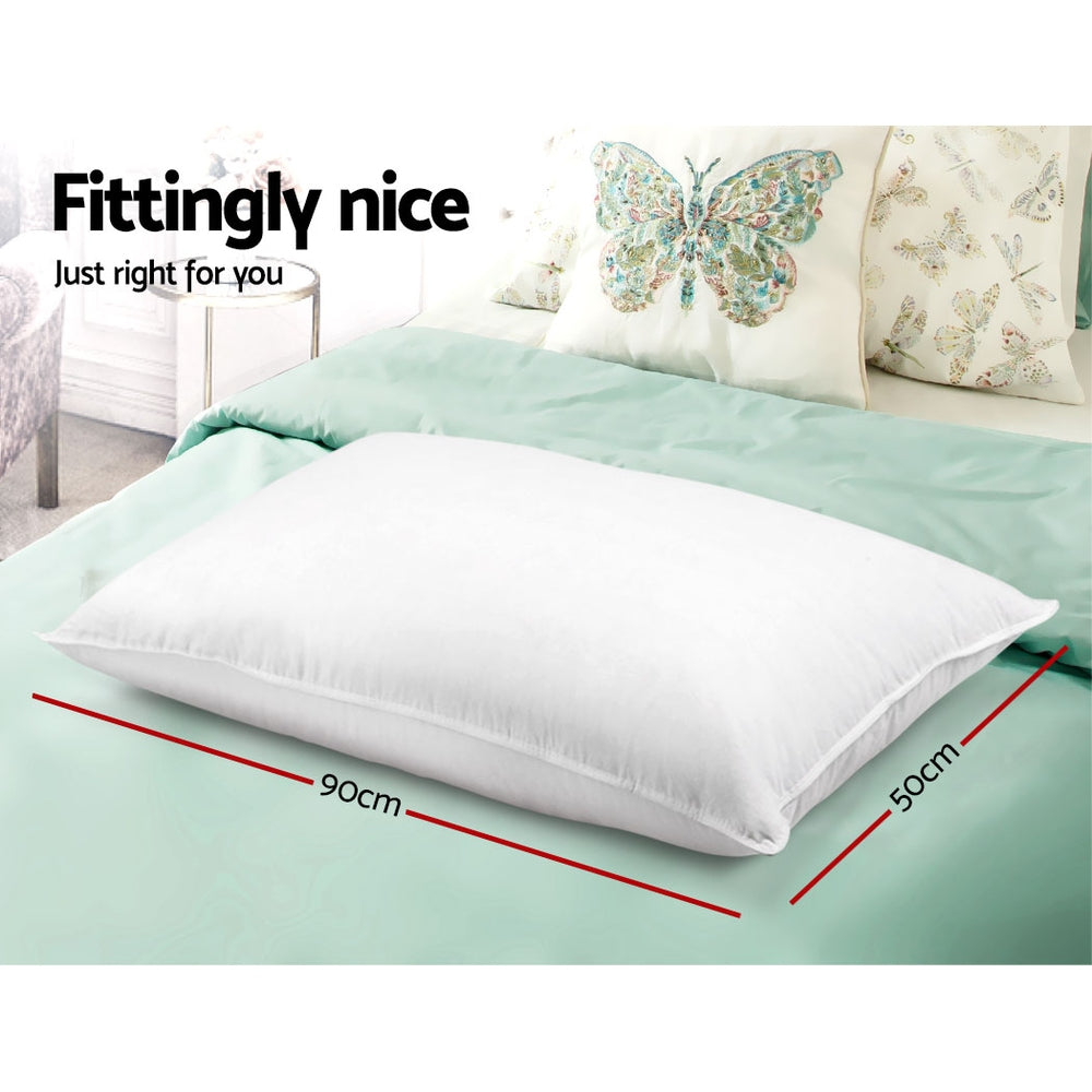 White bed pillow in hotel style with smooth cover, shown with size markings