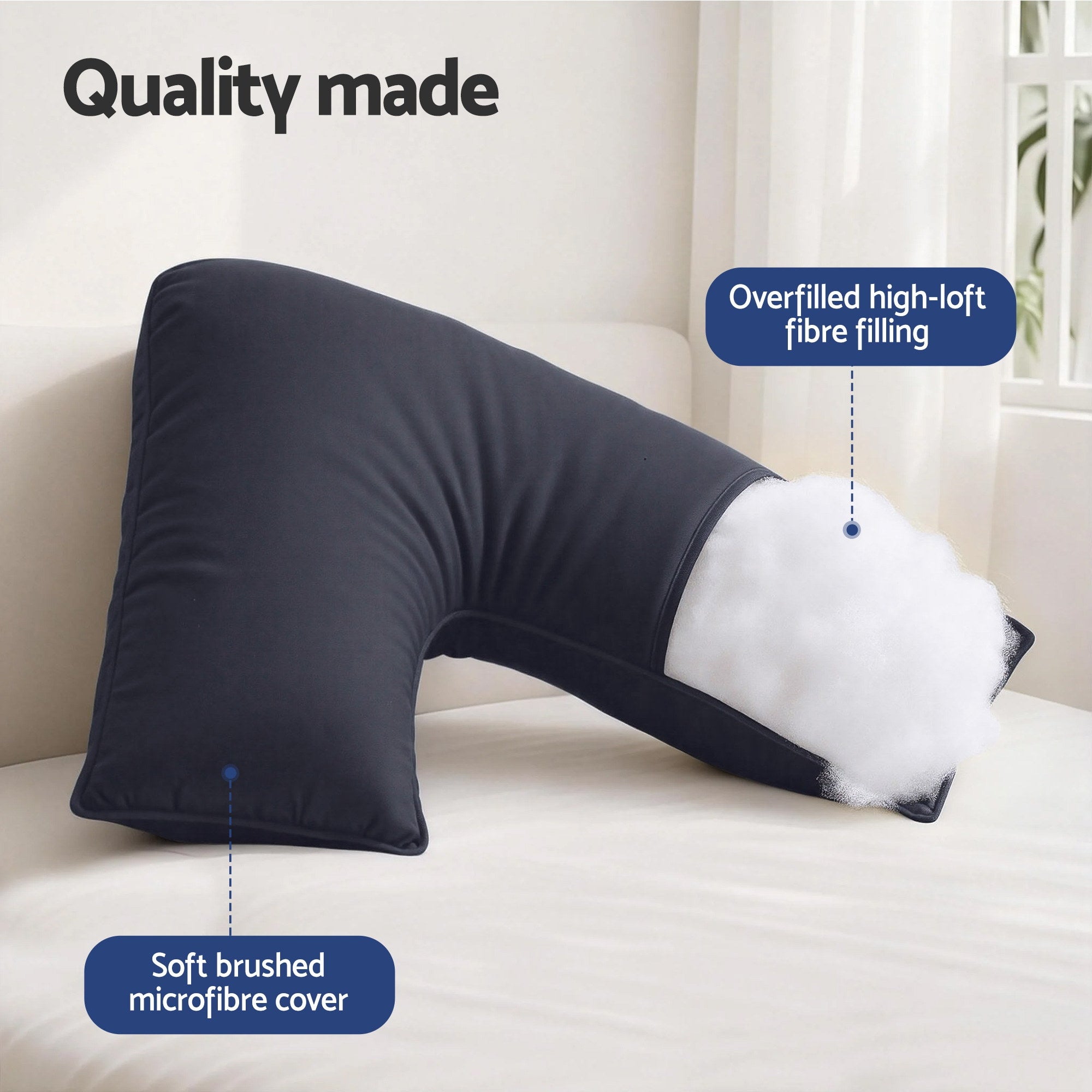 V-shaped body pillow with curved center cutout, dark fabric, thick overstuffed look