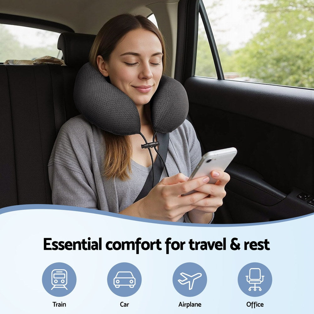 U-shaped neck pillow in dark gray on seated person’s car seat