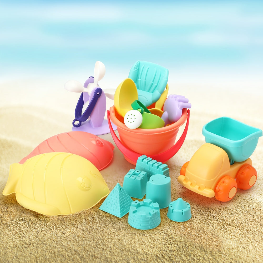 Kids sand play tool kit on sand with teal bucket, orange cart, shovels and molds