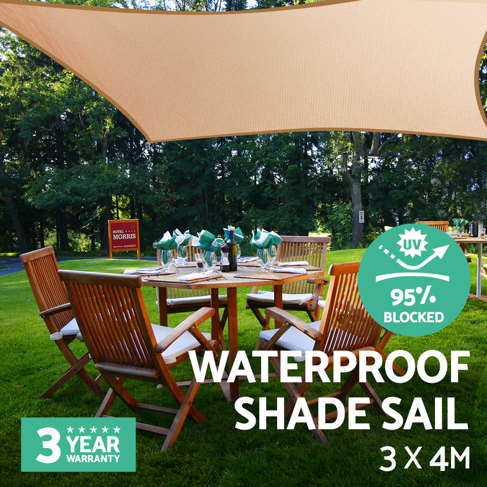 Sand waterproof shade sail 3x4m over outdoor dining table and chairs.