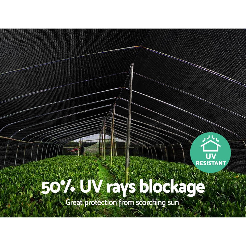 Black shade cloth tunnel canopy covering garden path with UV badge