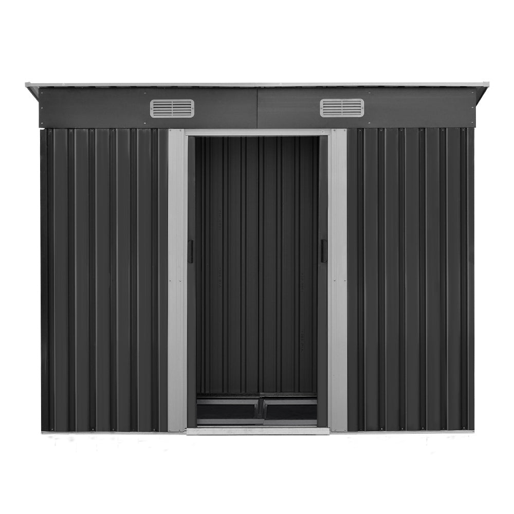 Outdoor storage shed front view, dark gray panels with open doorway and vents
