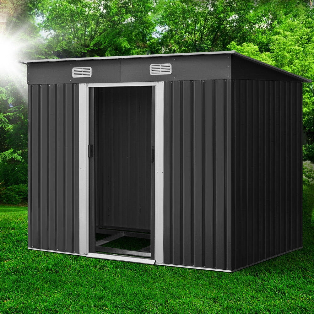 Outdoor metal storage shed, dark gray with open single door and vent panels