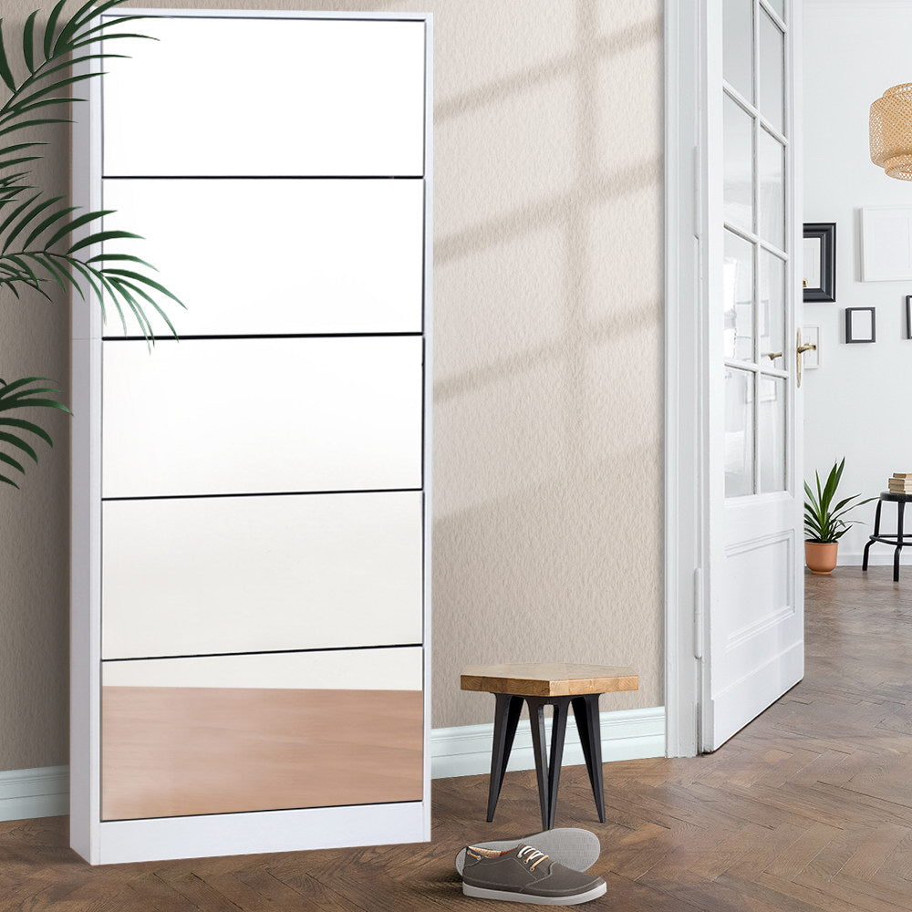 White mirrored shoe rack cabinet with open compartments standing in a room