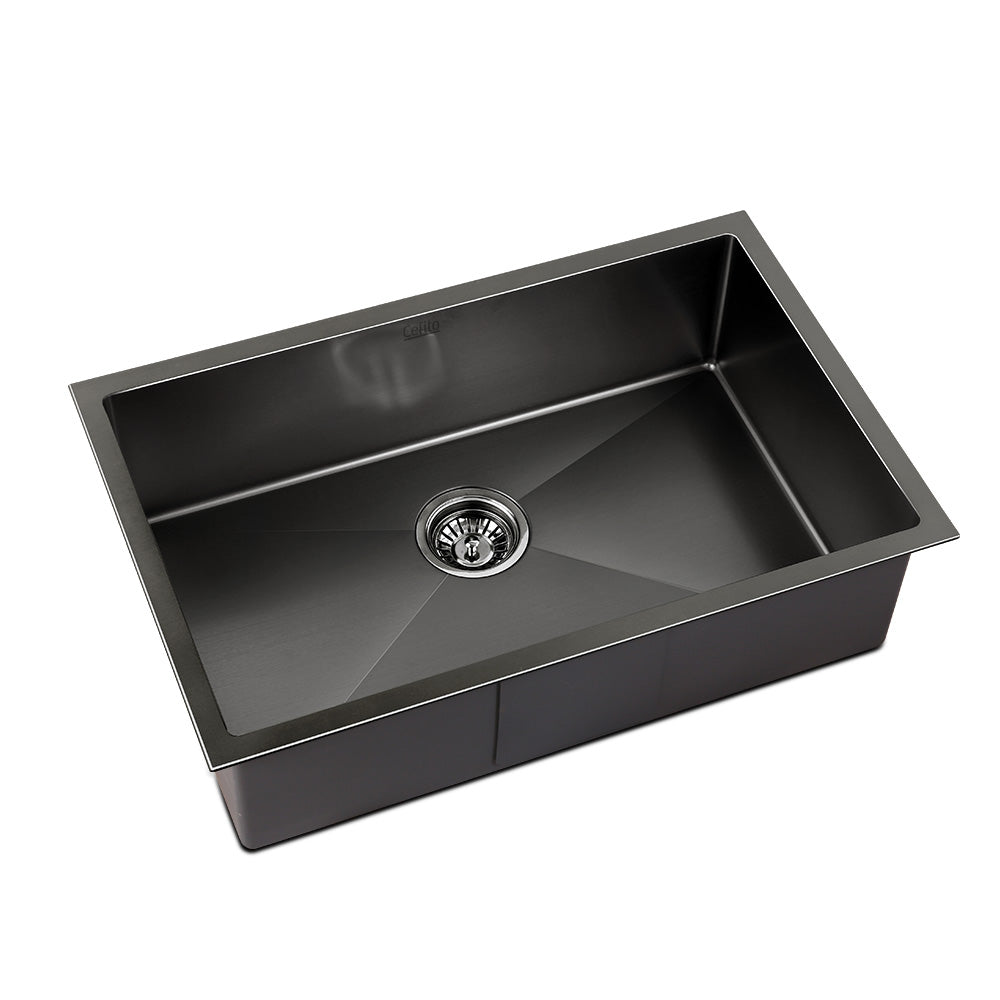 Black single-bowl kitchen sink with centered round drain and rectangular basin
