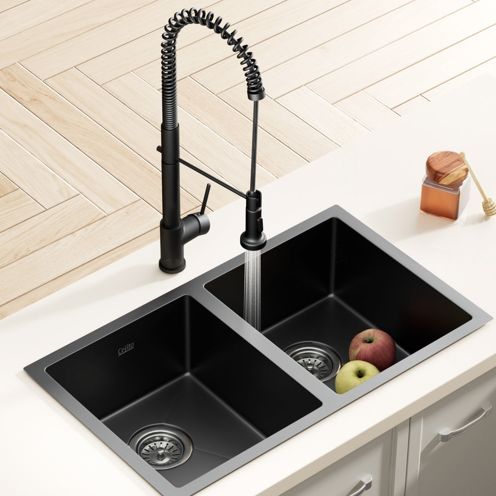 Black double-bowl sink with pull-out mixer tap and two basin drain strainers