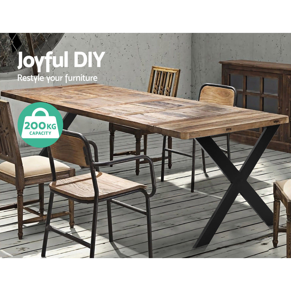Metal X-shaped table legs in black under a wooden dining table.