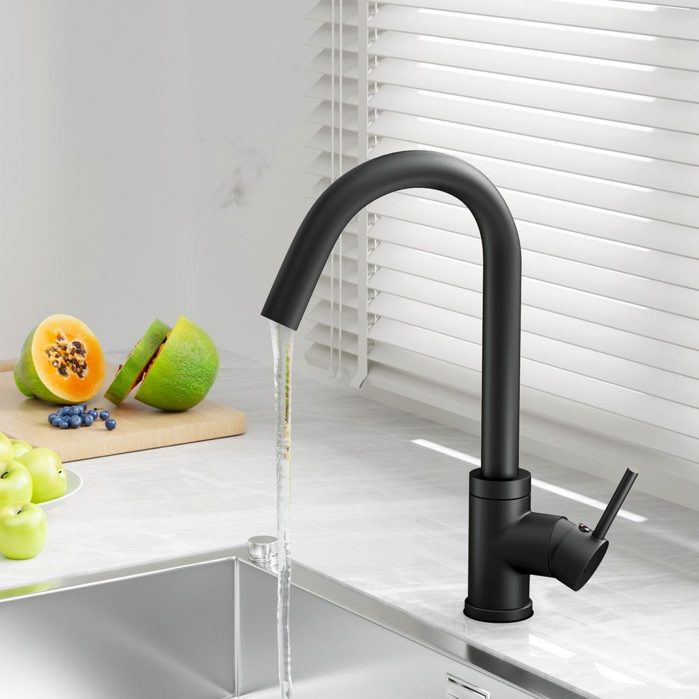 Black kitchen sink mixer tap dispensing water; tall arched spout with side control