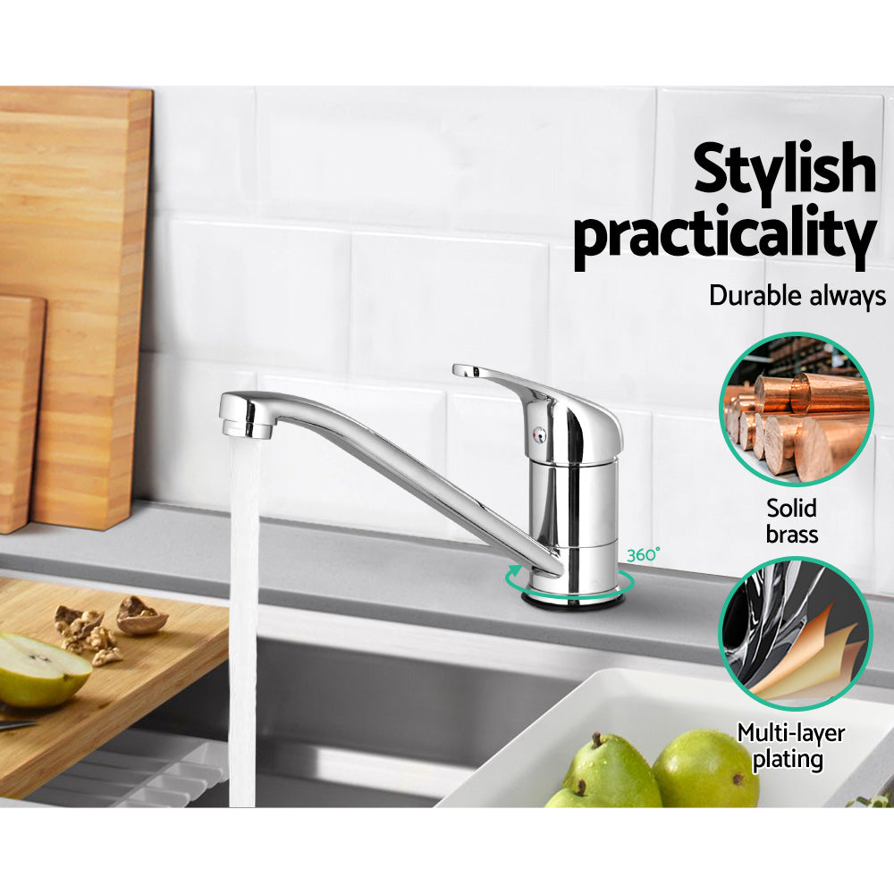 Chrome kitchen sink mixer tap with long spout and 360° base over white sink