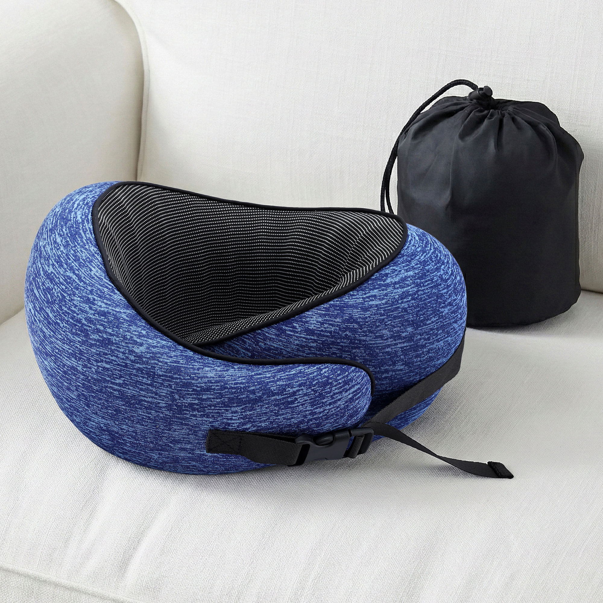 Blue ergonomic neck pillow with black inner lining and included black storage bag