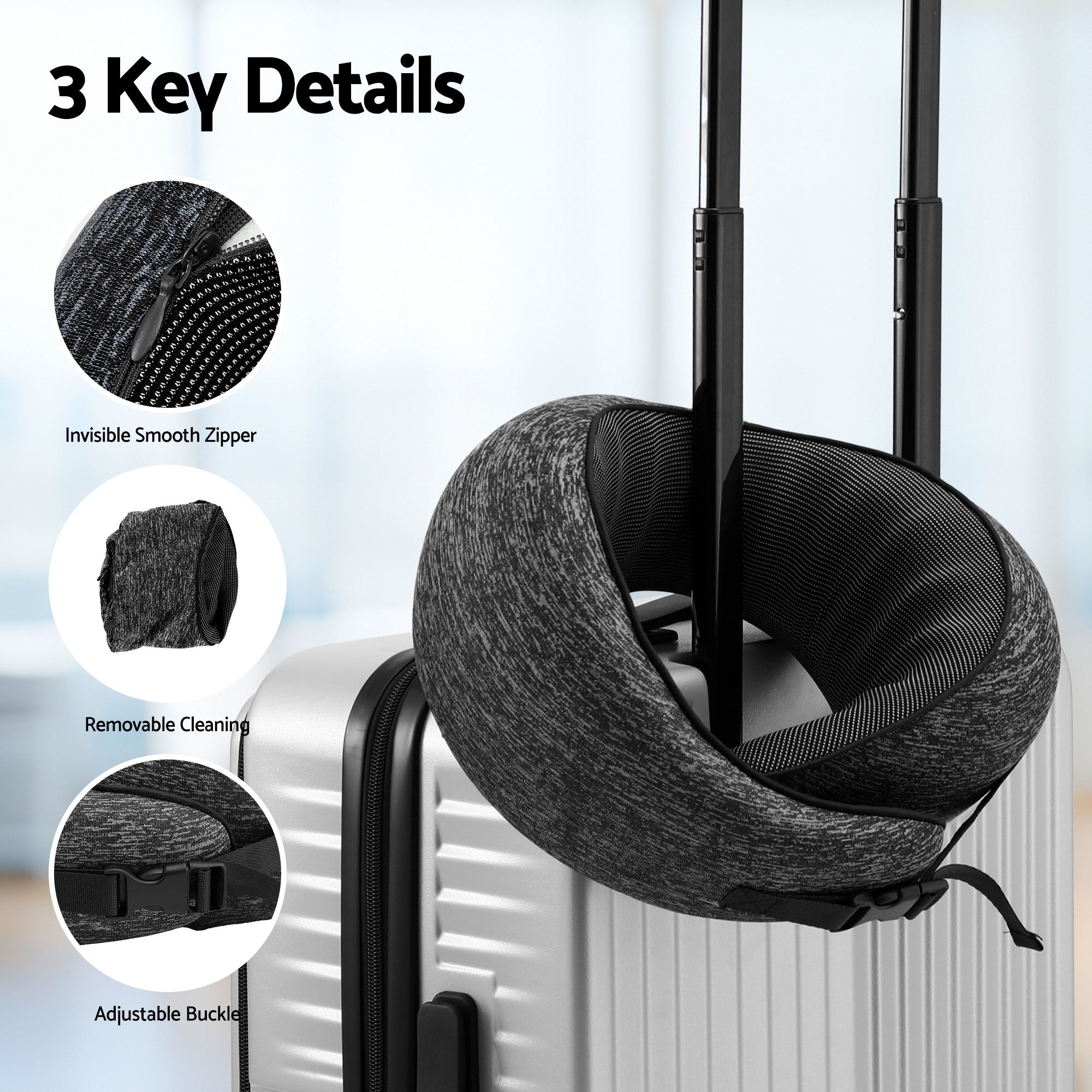 Dark grey travel neck pillow with strap buckles attached to suitcase handle