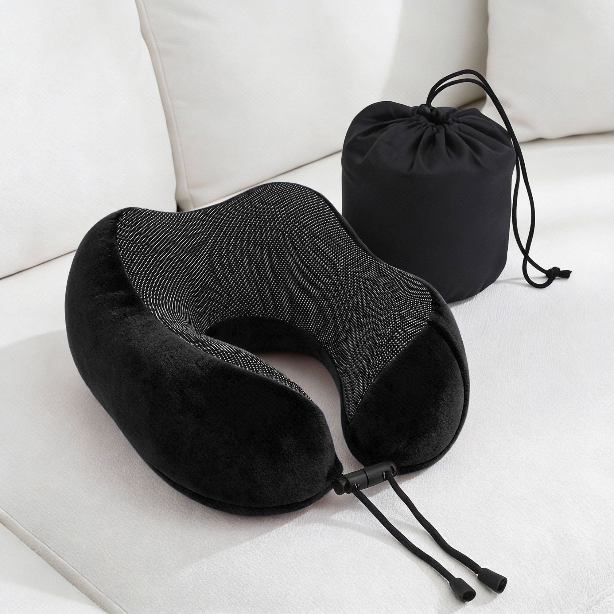 Black U-shaped memory foam neck pillow with matching drawstring storage bag