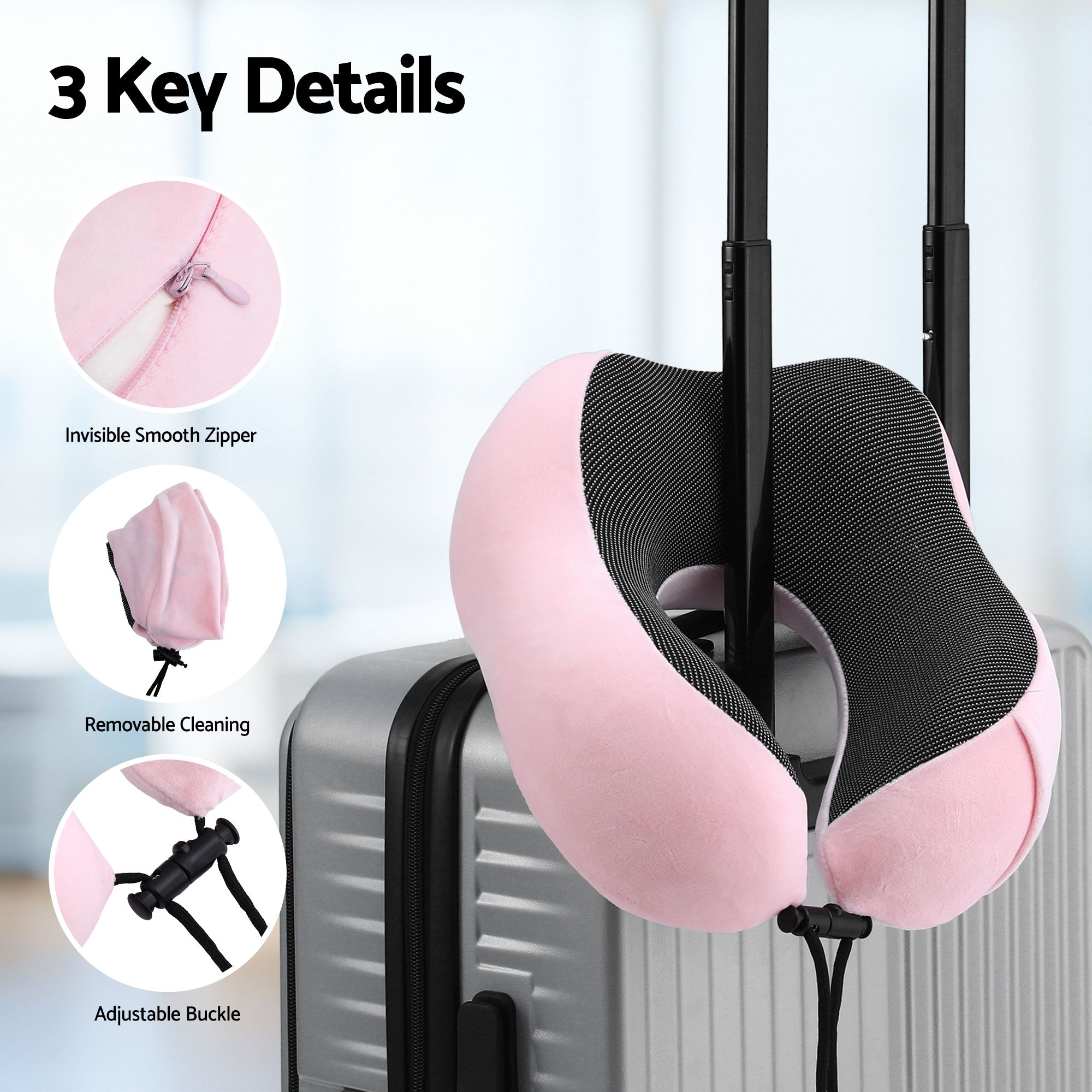 Pink travel neck pillow with black breathable insert clipped to suitcase handle