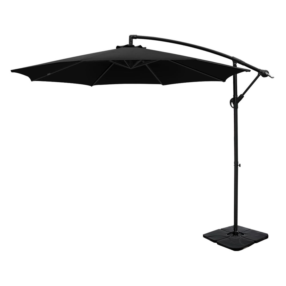 Black cantilever patio umbrella with open canopy and square weighted base