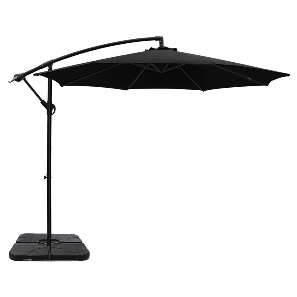Black cantilever patio umbrella with open canopy and square weighted base