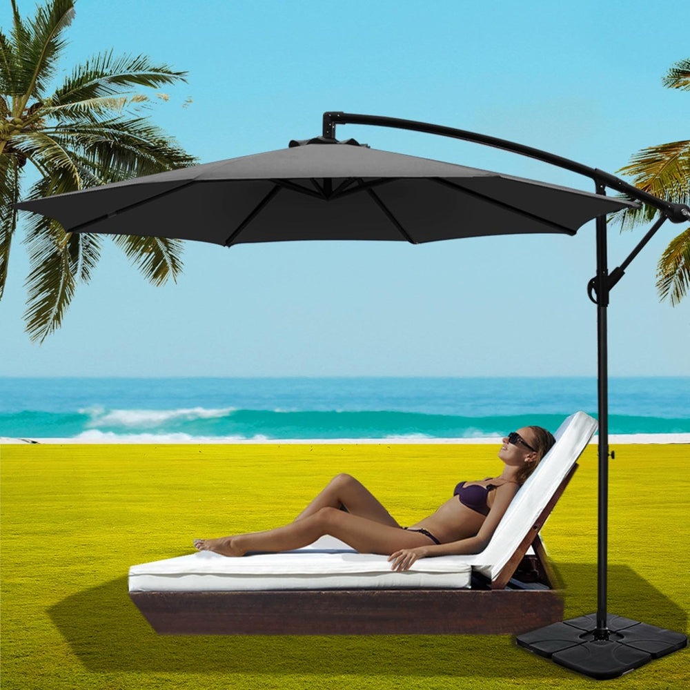 Charcoal cantilever patio umbrella with open canopy and rectangular base