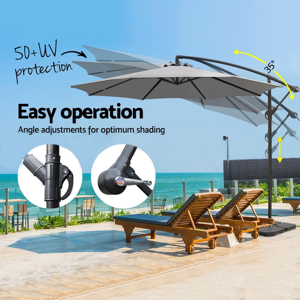 Grey cantilever patio umbrella with adjustable tilt mechanism on side support pole