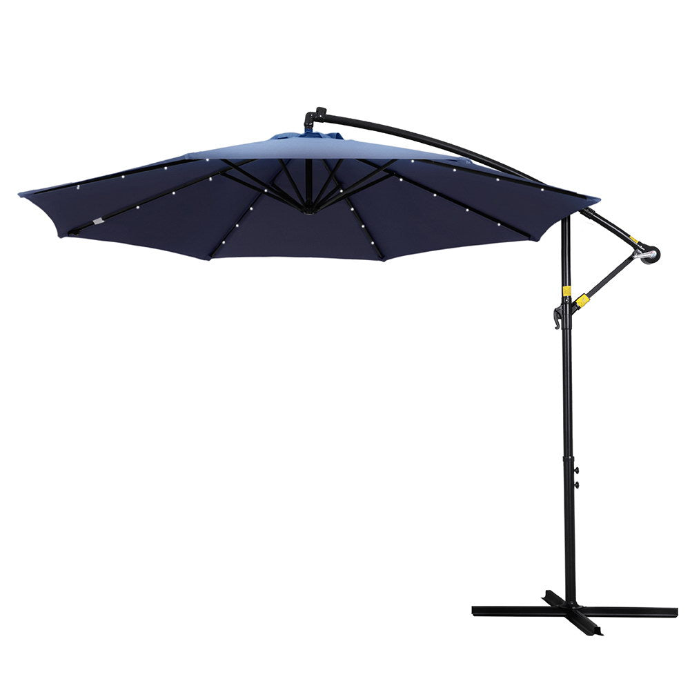 Cantilever outdoor umbrella with navy canopy and LED string lights