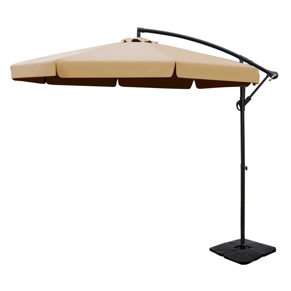 Beige cantilever patio umbrella with curved black pole and square weighted base