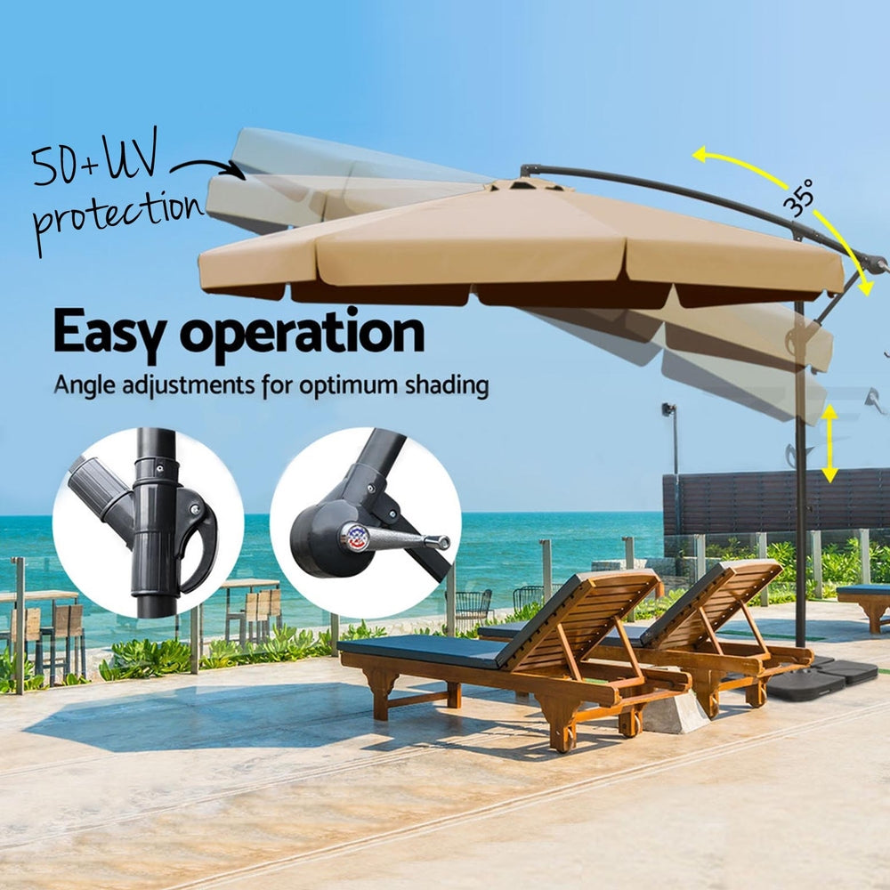 Beige cantilever outdoor umbrella with black arm and weighted base, angled