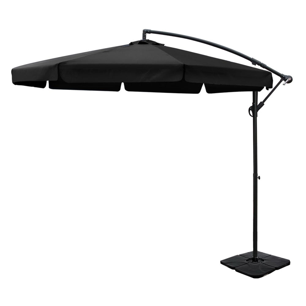 Black cantilever outdoor umbrella with canopy, arched support, and square base