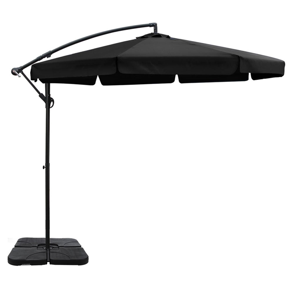 Black cantilever patio umbrella with extended canopy and square base, side view