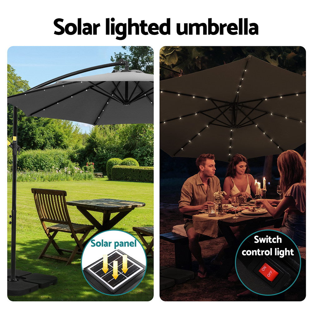 Solar-lit cantilever umbrella with black canopy and visible string lights under ribs
