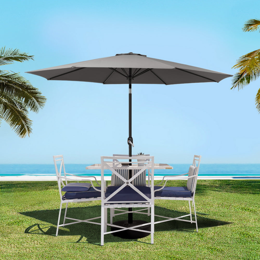 Charcoal outdoor patio umbrella standing on a round weighted base with open canopy
