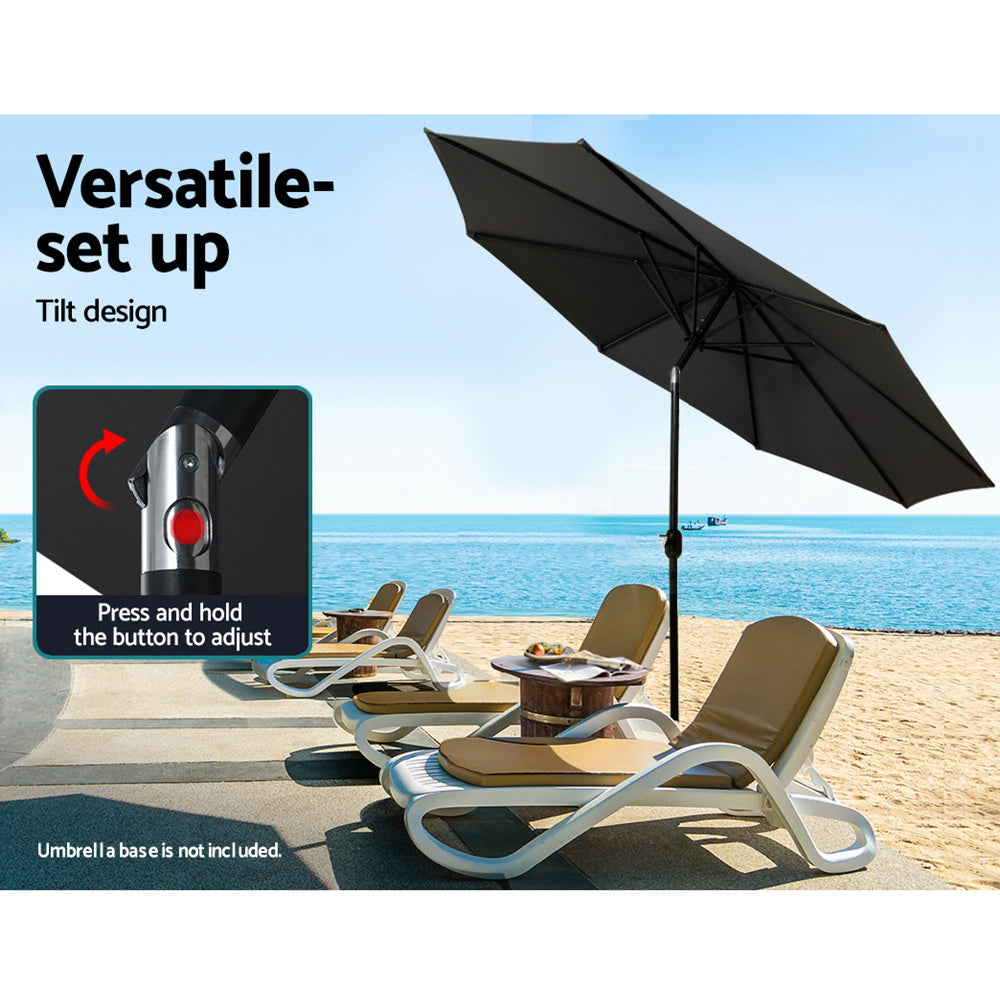 Black patio umbrella with tilt canopy and central pole over outdoor seating