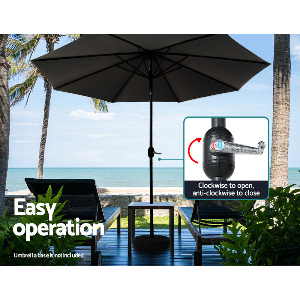 Black patio umbrella with tilt crank on central pole, open canopy