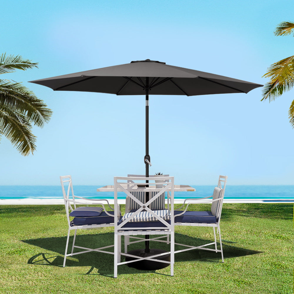 Open black patio umbrella on central pole over outdoor dining set