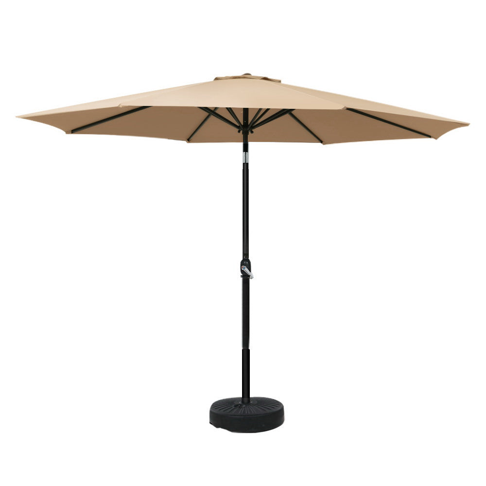 Beige tilting outdoor umbrella with black pole and round weighted base