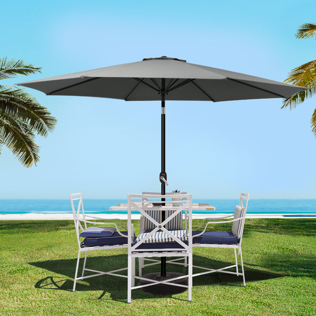 Charcoal outdoor umbrella shading a patio set with chairs and open dark canopy