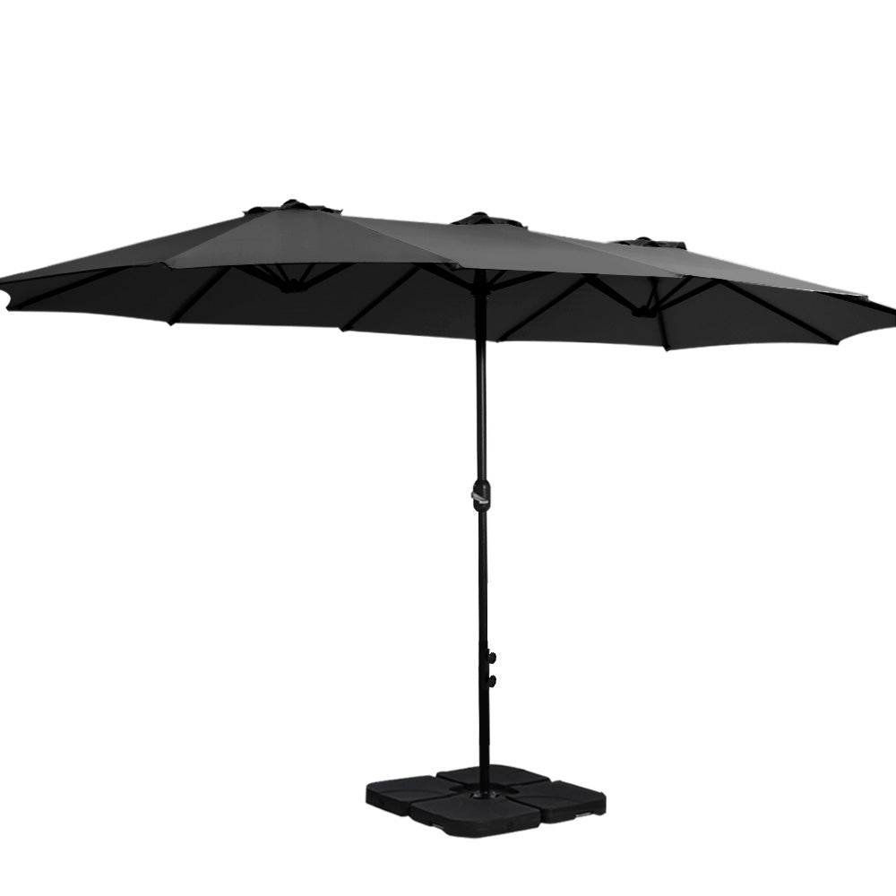 Black outdoor patio umbrella with base stand and center pole.
