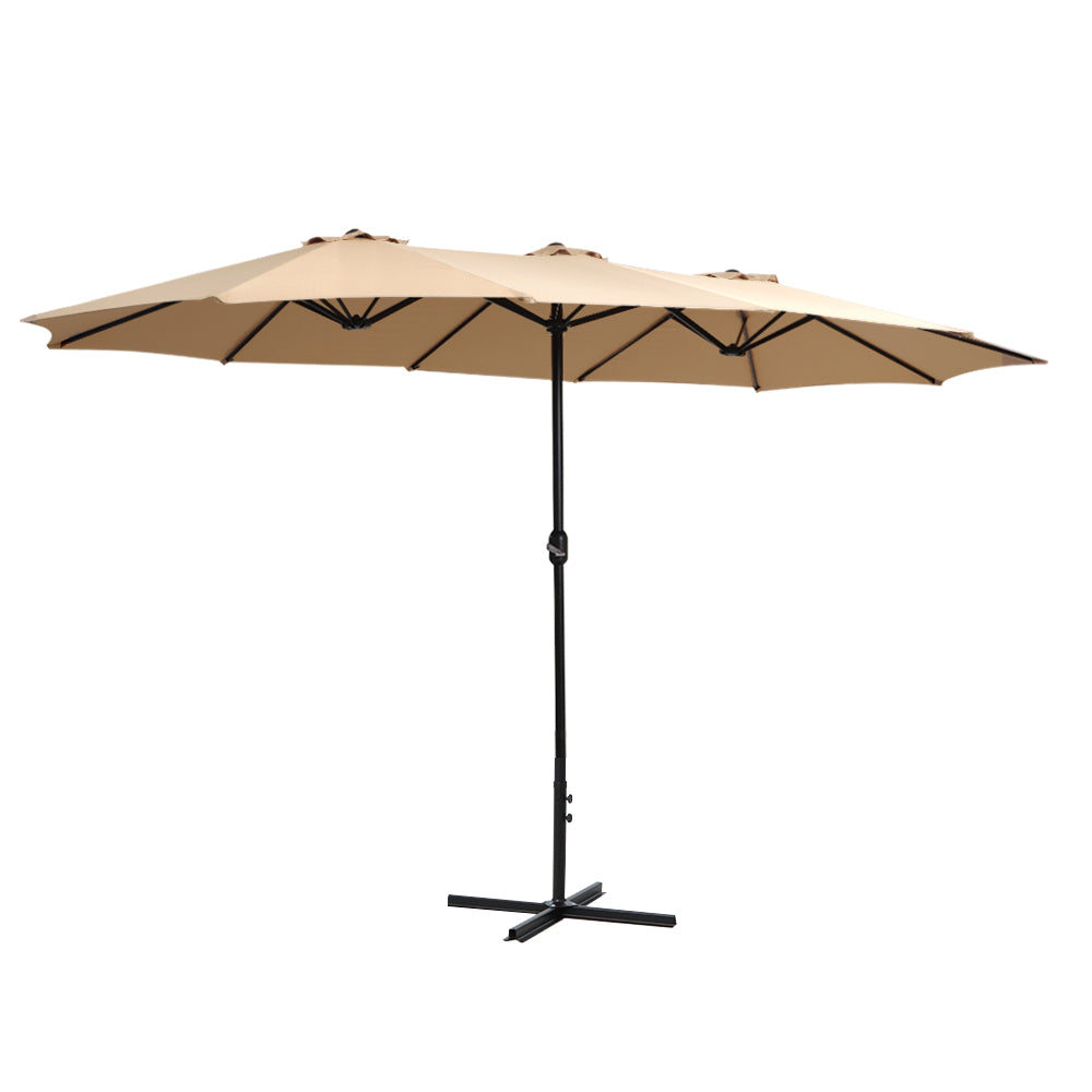 Beige outdoor patio umbrella with black center pole and cross base