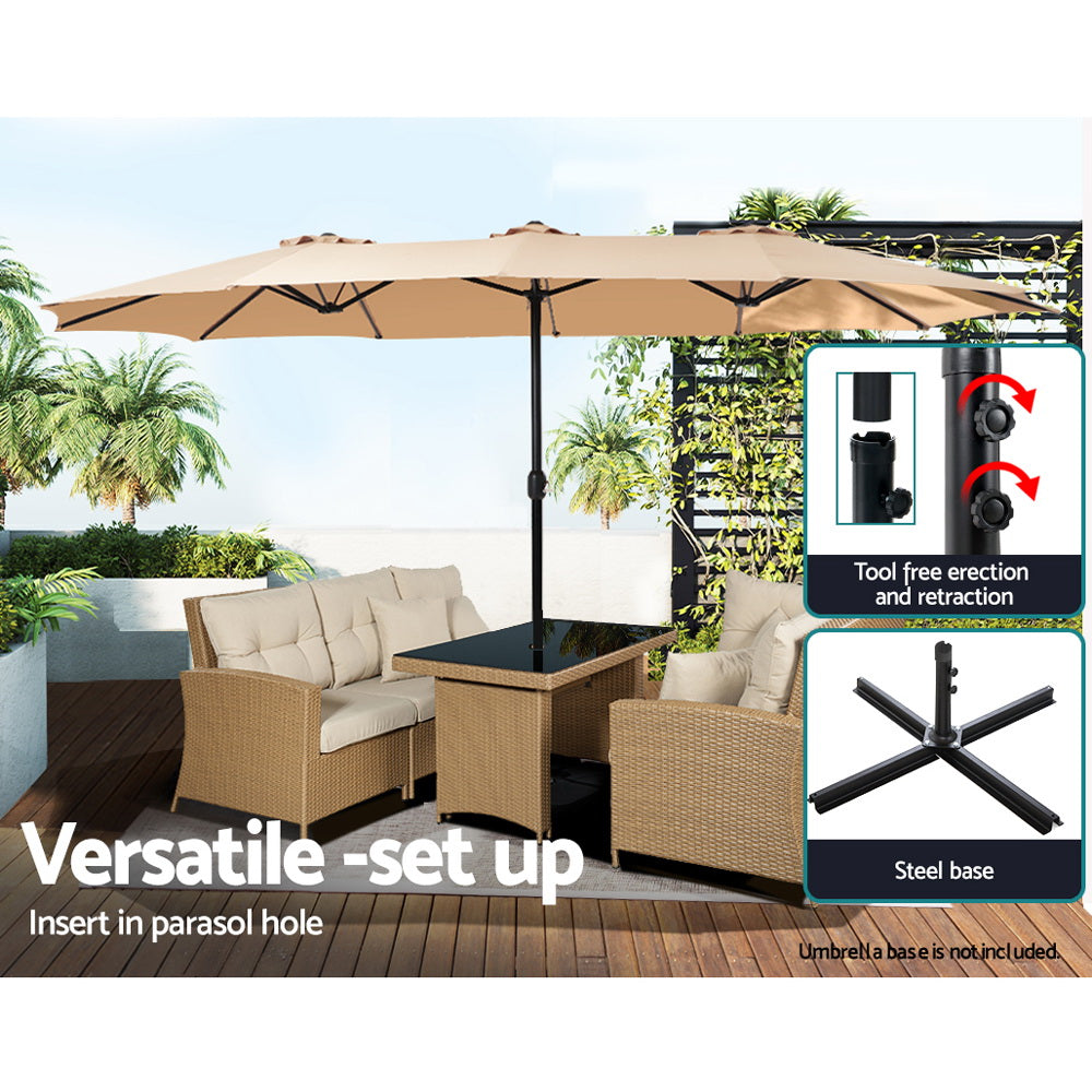 Beige patio umbrella over outdoor seating with black center pole