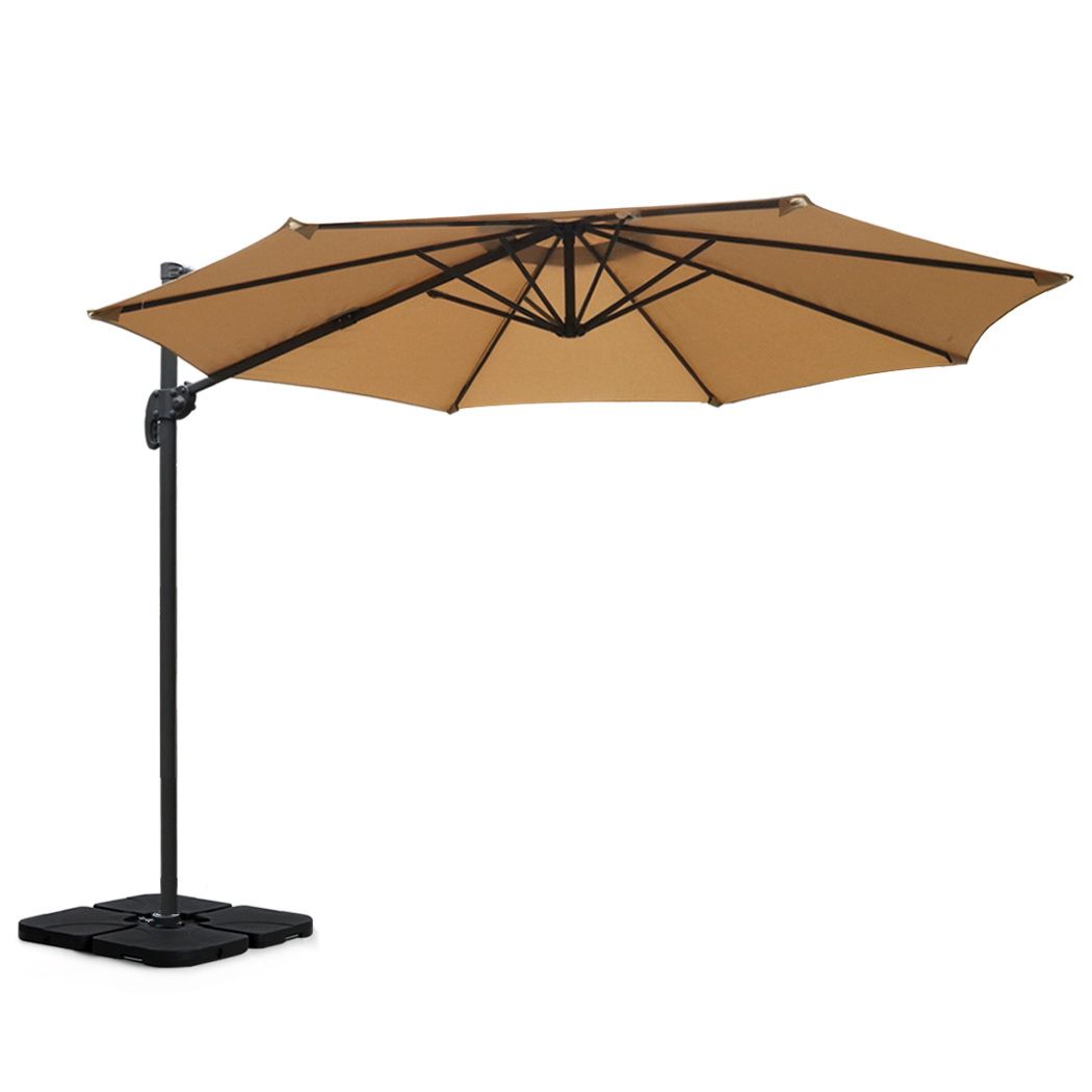 Beige cantilever patio umbrella with open canopy and black square base