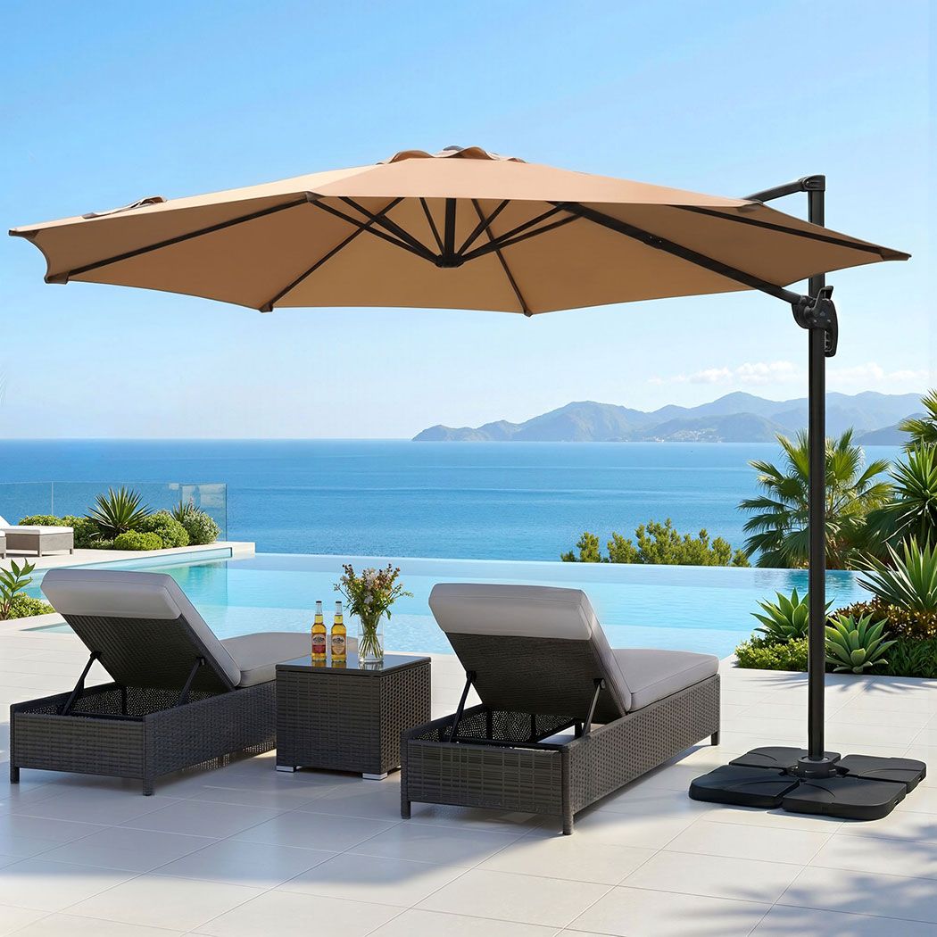 Beige cantilever patio umbrella open with black center pole and square base
