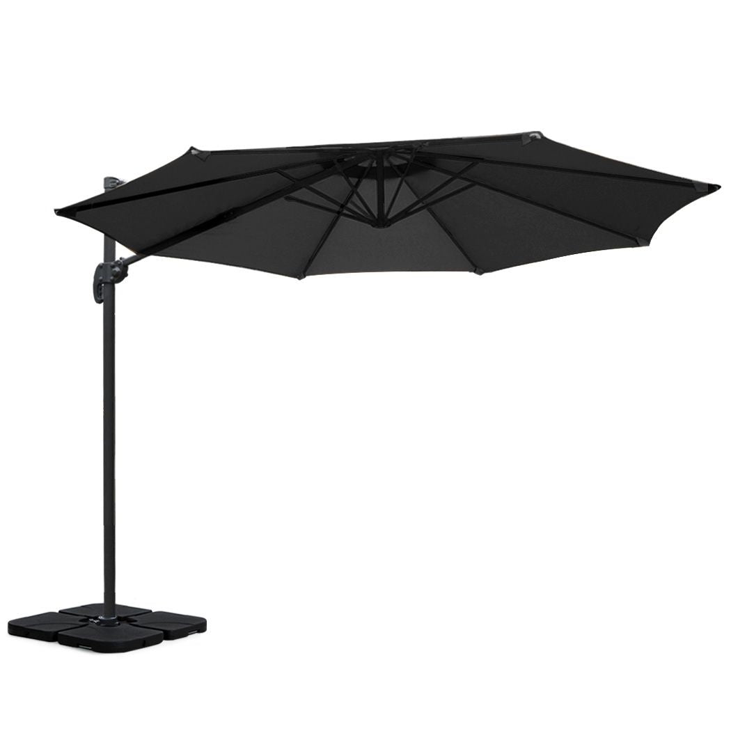 Black cantilever patio umbrella with square weighted base and side support pole